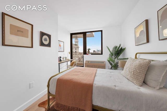 136 E Broadway Pha, Pha, New York City, NY 10002 - bedroom with wood finished floors, access to exterior, expansive windows, and a wall unit AC