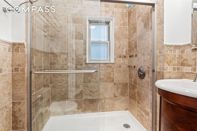 155 E 49th St Unit 8C, New York City, NY 10017 - bathroom featuring a stall shower, vanity, and tile walls