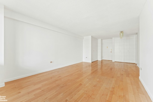 77 Fulton St Unit 9N, New York City, NY 10038 - unfurnished room with light wood-style floors and baseboards