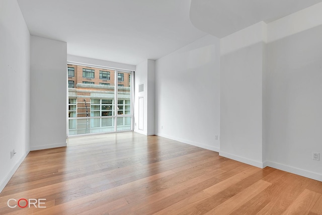 311 W Broadway Unit 3C, New York City, NY 10013 - unfurnished room with wood finished floors and baseboards