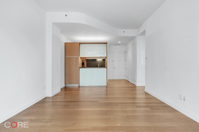 311 W Broadway Unit 3C, New York City, NY 10013 - unfurnished living room with light wood-style floors and baseboards
