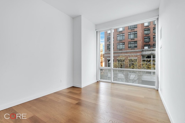 311 W Broadway Unit 3C, New York City, NY 10013 - unfurnished room featuring wood finished floors and baseboards