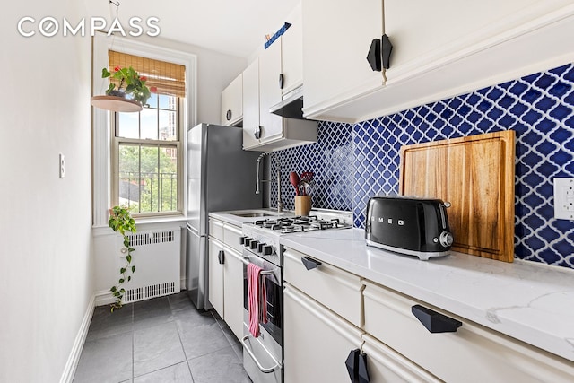 145 Hicks St Unit A55, New York City, NY 11201 - kitchen featuring stainless steel appliances, radiator, and white cabinets
