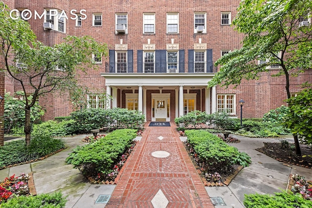 145 Hicks St Unit A55, New York City, NY 11201 - view of front of home featuring brick siding, a porch, and cooling unit
