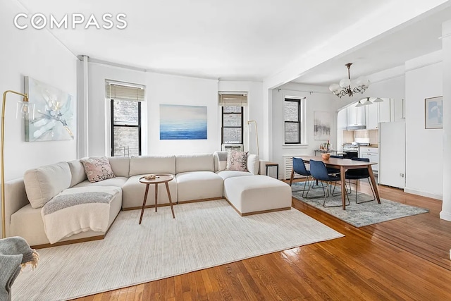 250 W 22nd St Unit 2C, New York City, NY 10011 - living area featuring light wood-type flooring and a chandelier