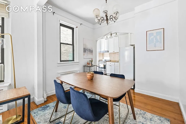 250 W 22nd St Unit 2C, New York City, NY 10011 - dining space with a chandelier and light wood-style floors