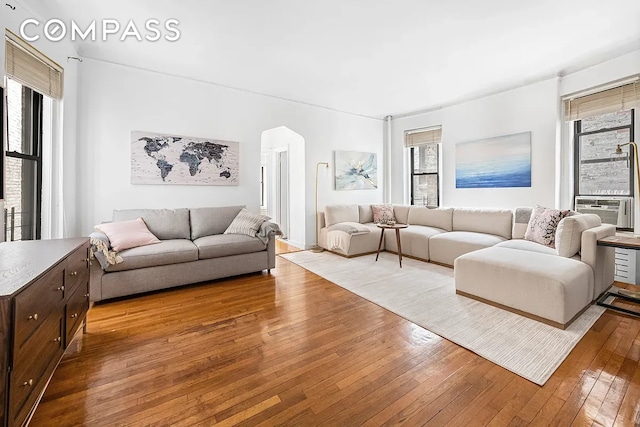 250 W 22nd St Unit 2C, New York City, NY 10011 - living area with hardwood / wood-style flooring, plenty of natural light, and arched walkways