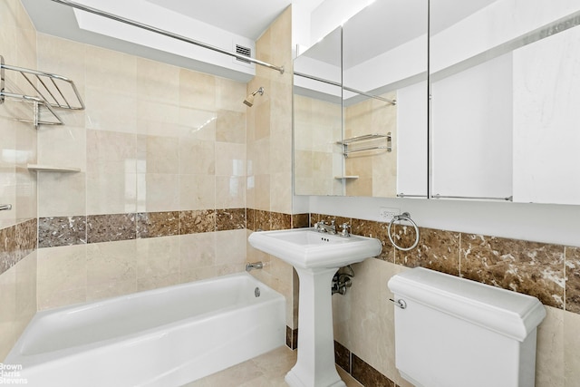 235 E 55th St Unit 41B, New York City, NY 10022 - bathroom featuring bathing tub / shower combination and tile walls
