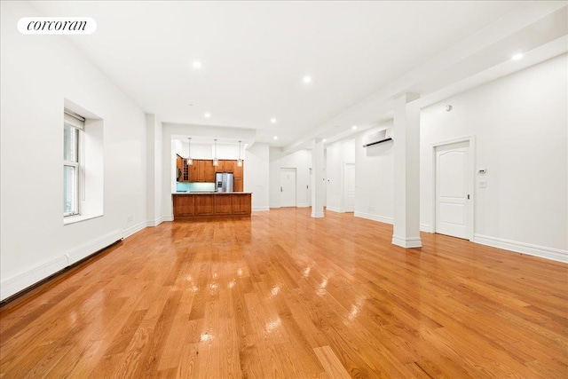 458 W 146th St Unit 2S, New York City, NY 10031 - unfurnished living room with a wall mounted air conditioner, light wood-style floors, recessed lighting, and a baseboard radiator