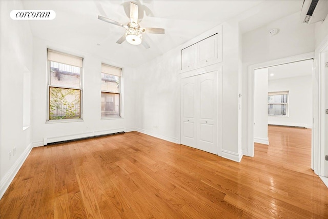 458 W 146th St Unit 2S, New York City, NY 10031 - spare room with a baseboard radiator, light wood-type flooring, a ceiling fan, and plenty of natural light