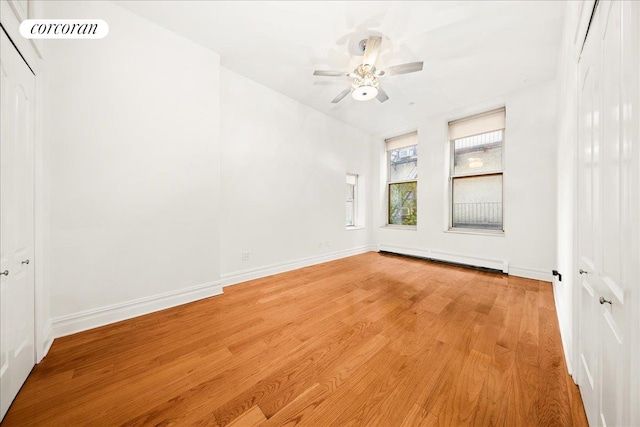 458 W 146th St Unit 2S, New York City, NY 10031 - empty room with a baseboard radiator, light wood-style floors, and ceiling fan