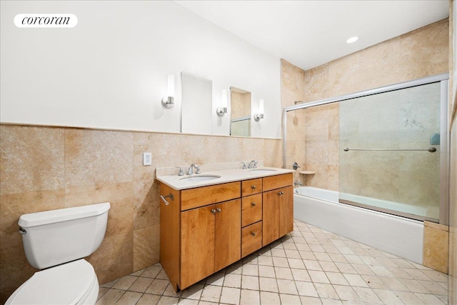 458 W 146th St Unit 2S, New York City, NY 10031 - bathroom featuring double vanity, combined bath / shower with glass door, tile walls, and tile patterned flooring