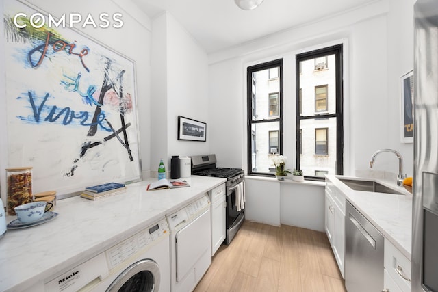 993 Park Ave Unit 4C, New York City, NY 10028 - kitchen with stainless steel appliances, plenty of natural light, light wood-type flooring, and white cabinetry