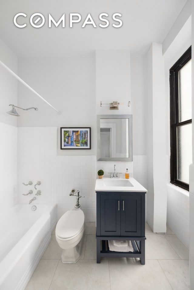 993 Park Ave Unit 4C, New York City, NY 10028 - bathroom with tile walls, vanity, bathing tub / shower combination, tile patterned floors, and wainscoting
