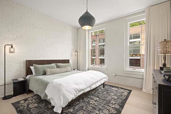 168 Plymouth St Unit 4-D, New York City, NY 11201 - bedroom featuring brick wall and light wood finished floors