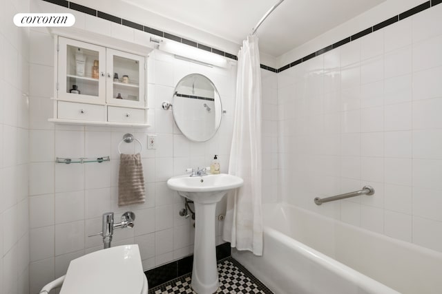 410 W 24th St Unit 10M, New York City, NY 10011 - full bathroom with shower / tub combo with curtain, tile walls, and tile patterned flooring