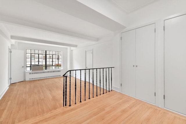 10 Park Ave Unit 4-C, New York City, NY 10016 - unfurnished room featuring radiator heating unit, wood finished floors, beamed ceiling, and cooling unit
