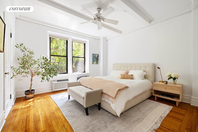 120 W 70th St Unit 1D, New York City, NY 10023 - bedroom featuring a wall mounted air conditioner, wood finished floors, beam ceiling, and ceiling fan