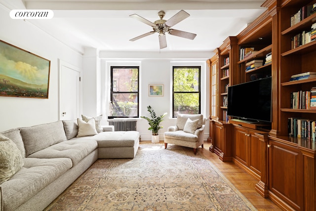 120 W 70th St Unit 1D, New York City, NY 10023 - living area featuring radiator heating unit, light wood finished floors, and ceiling fan