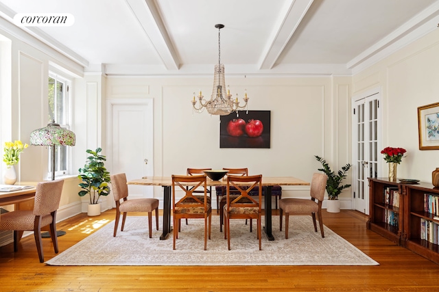 120 W 70th St Unit 1D, New York City, NY 10023 - dining room featuring a chandelier, wood finished floors, and beamed ceiling