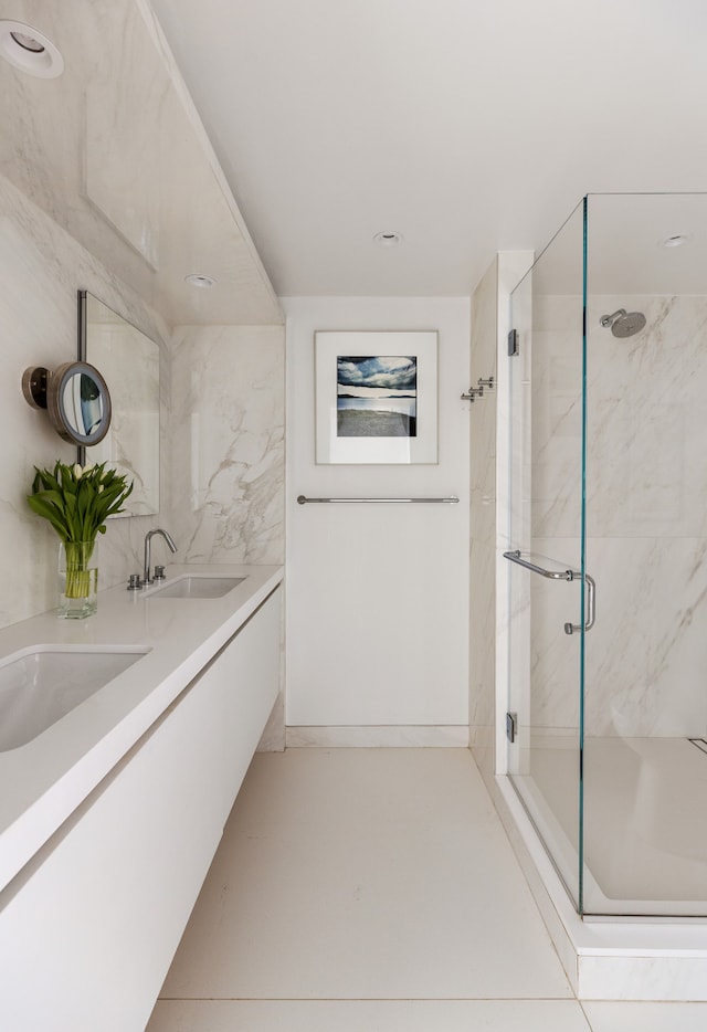 45 Sutton Pl S Unit 8H, New York City, NY 10022 - bathroom featuring a stall shower, double vanity, and recessed lighting
