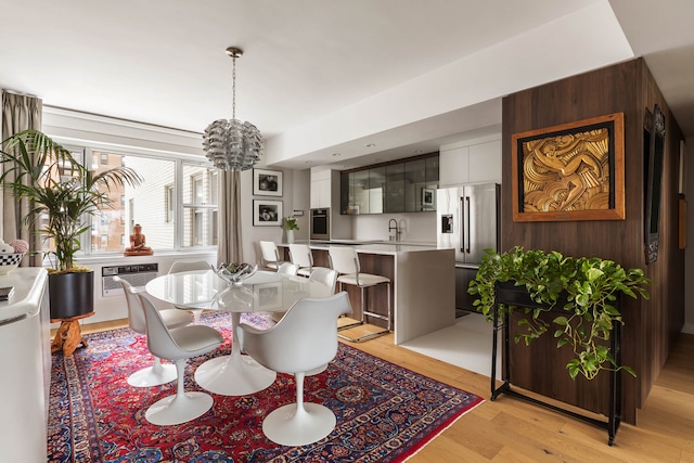 45 Sutton Pl S Unit 8H, New York City, NY 10022 - dining room with a chandelier, light wood-style floors, and a wall mounted AC
