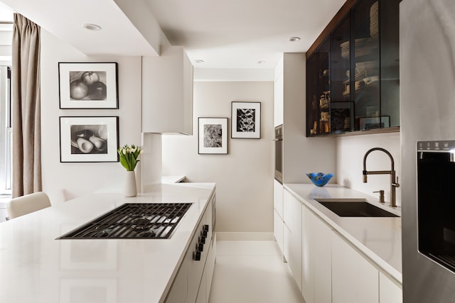45 Sutton Pl S Unit 8H, New York City, NY 10022 - kitchen with appliances with stainless steel finishes, white cabinets, light countertops, and recessed lighting