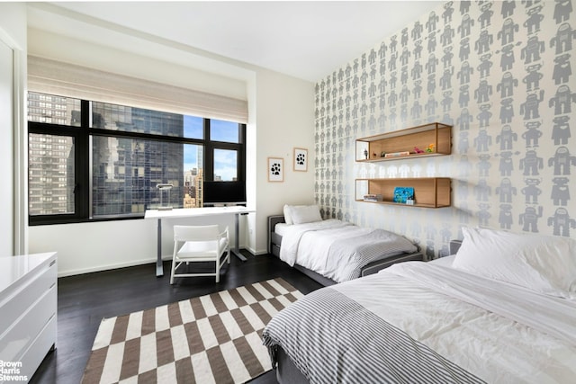 50 United Nations Plz Unit 28B, New York City, NY 10017 - bedroom with an accent wall, wood finished floors, and wallpapered walls