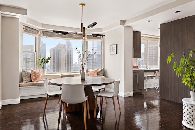 300 E 74th St Unit 23G, New York City, NY 10021 - dining room with dark wood-style floors, a view of city, and recessed lighting