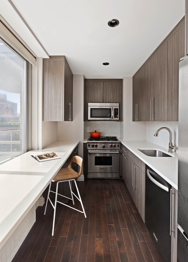 300 E 74th St Unit 23G, New York City, NY 10021 - kitchen featuring stainless steel appliances, modern cabinets, light countertops, tasteful backsplash, and dark wood-type flooring