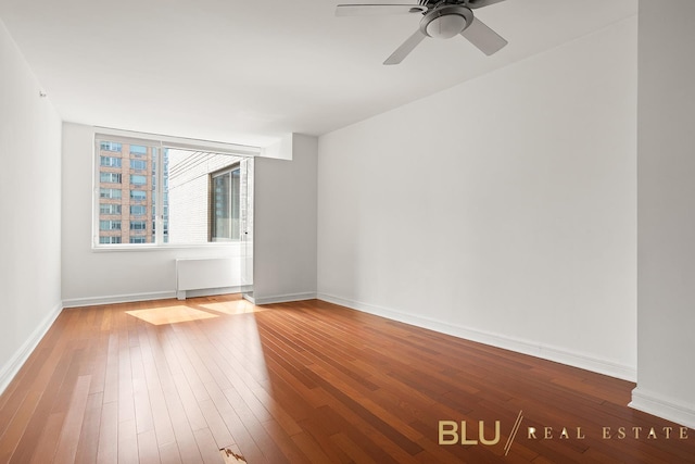 100 Riverside Blvd Unit 8-T, New York City, NY 10069 - spare room featuring wood-type flooring, a ceiling fan, and radiator