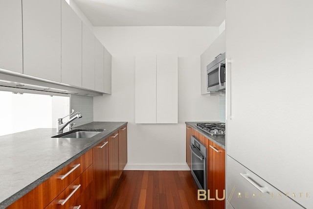 100 Riverside Blvd Unit 8-T, New York City, NY 10069 - kitchen featuring stainless steel appliances, modern cabinets, dark wood-type flooring, and brown cabinets
