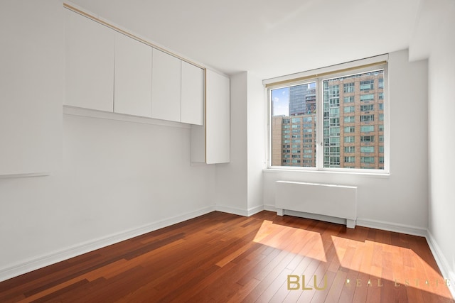 100 Riverside Blvd Unit 8-T, New York City, NY 10069 - spare room featuring radiator heating unit and dark wood-type flooring