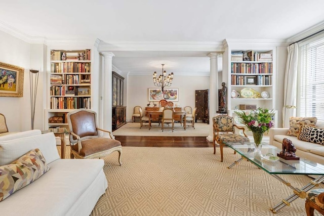 1105 Park Ave Unit 6D, New York City, NY 10128 - sitting room featuring ornate columns, wood finished floors, a chandelier, built in shelves, and ornamental molding
