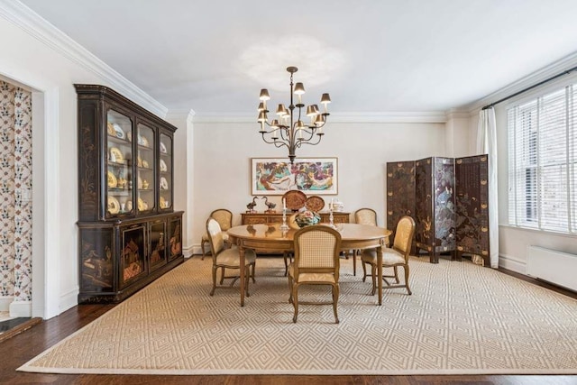 1105 Park Ave Unit 6D, New York City, NY 10128 - dining space featuring a chandelier, crown molding, and wood finished floors