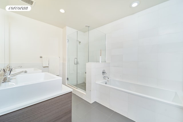 125 W 22nd St Unit 9B, New York City, NY 10011 - full bath featuring tile patterned flooring, a stall shower, a garden tub, recessed lighting, and vanity