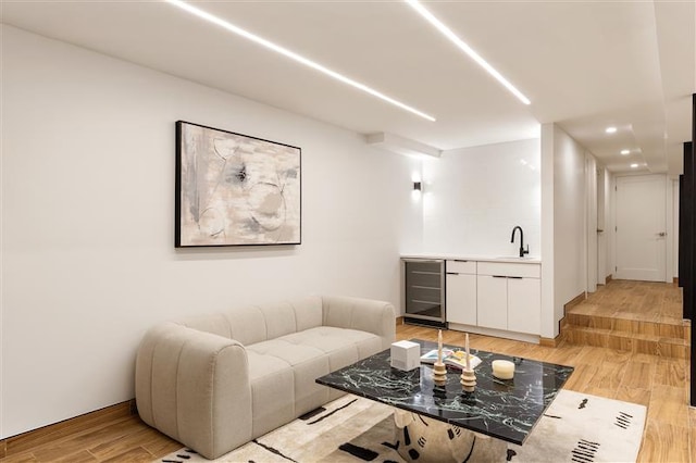 384 Hancock St, New York City, NY 11216 - living area featuring beverage cooler, light wood-type flooring, bar with sink, and recessed lighting