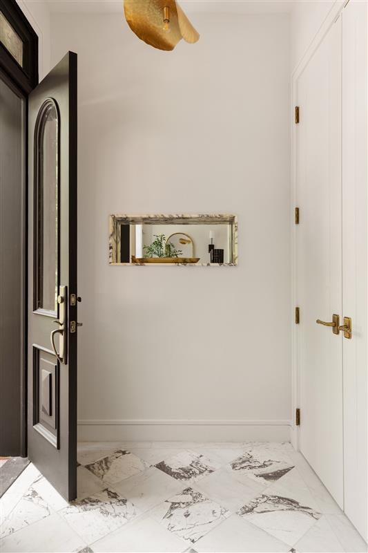 384 Hancock St, New York City, NY 11216 - entrance foyer with marble look tiles and baseboards