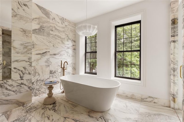 384 Hancock St, New York City, NY 11216 - full bath with a freestanding tub and marble tiled floors