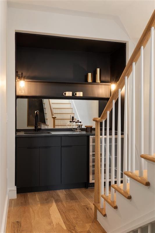 384 Hancock St, New York City, NY 11216 - indoor wet bar featuring light wood-type flooring and stairway