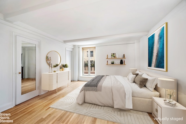 433 E 51st St Unit 11E, New York City, NY 10022 - bedroom with light wood-type flooring and access to exterior