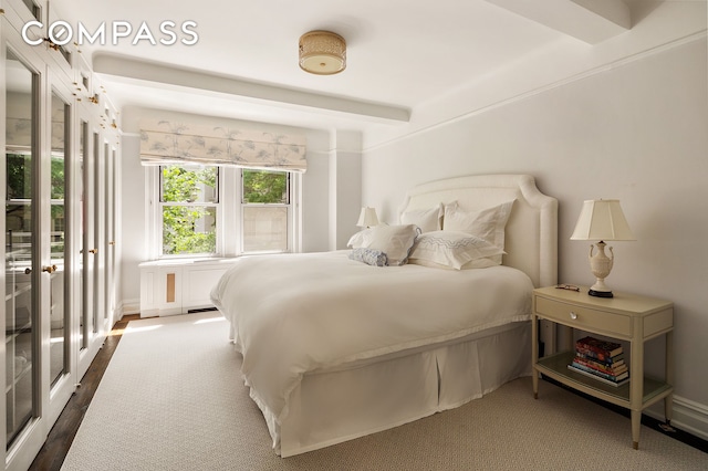 163 E 81st St Unit 3A, New York City, NY 10028 - bedroom with baseboards and dark wood finished floors