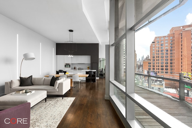 1 York St Unit 6E, New York City, NY 10013 - living area featuring dark wood-style floors, healthy amount of natural light, a chandelier, and a view of city