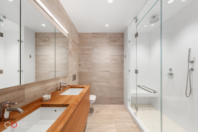 1 York St Unit 6E, New York City, NY 10013 - bathroom with tile walls, a stall shower, double vanity, recessed lighting, and backsplash