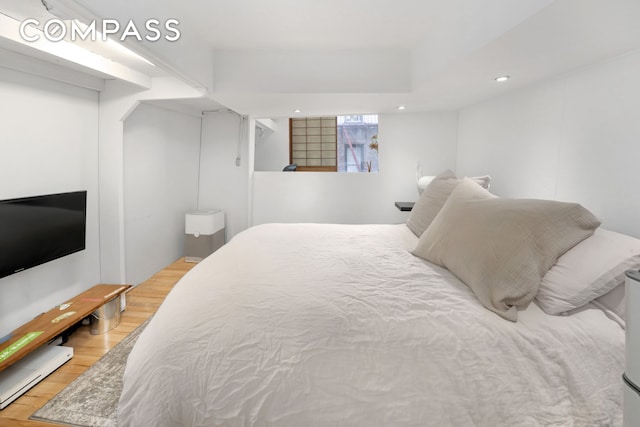 415 W 55th St Unit 4D, New York City, NY 10019 - bedroom with wood finished floors, recessed lighting, and a baseboard radiator