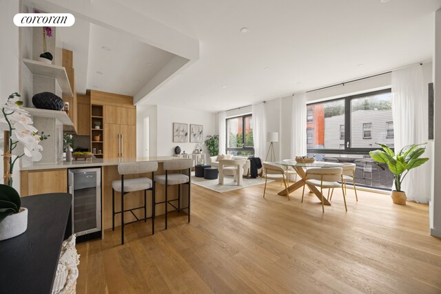 658 Washington Ave Unit 2, New York City, NY 11238 - kitchen with wine cooler, open shelves, modern cabinets, light wood finished floors, and open floor plan