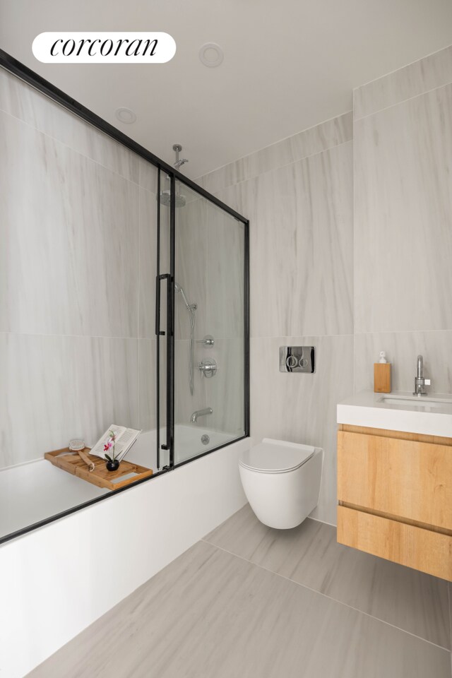 658 Washington Ave Unit 2, New York City, NY 11238 - bathroom featuring tile walls, combined bath / shower with glass door, and vanity