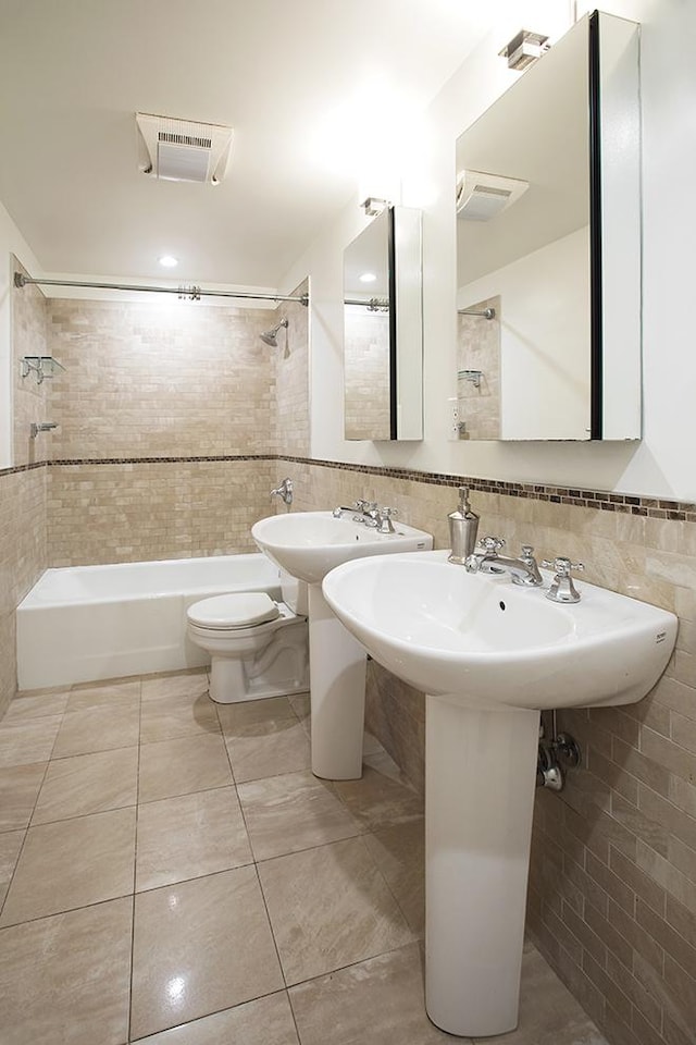 150 W 51st St Unit 1623, New York City, NY 10019 - full bathroom featuring tile walls, shower / bath combination, and tile patterned flooring