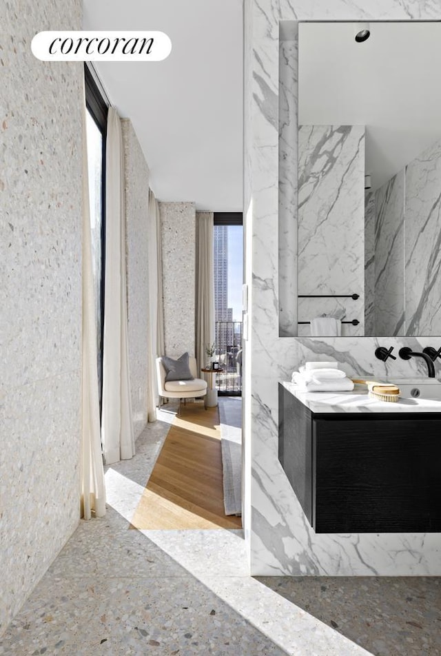 16 W 40th St Unit 25B, New York City, NY 10018 - bathroom with stone wall and vanity