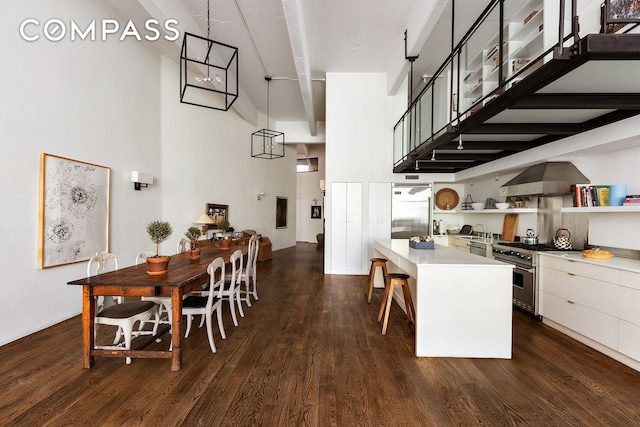 377 W 11th St Unit 3A, New York City, NY 10014 - dining area with a towering ceiling and dark wood-style floors